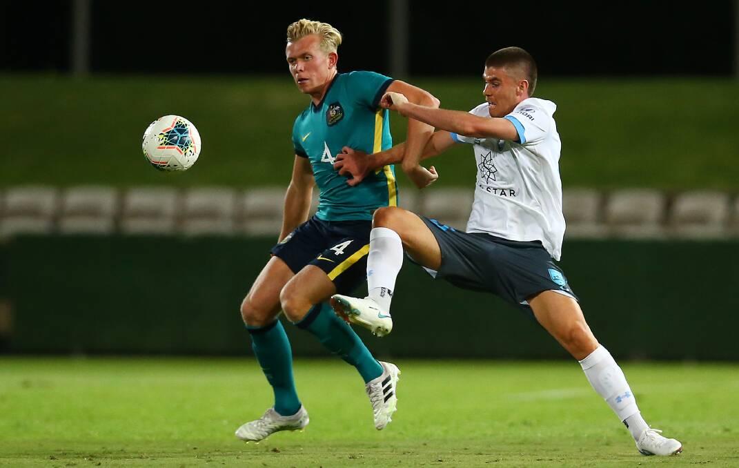 FOCUSED: Olyroos midfielder Joshua Laws (left) challenges his Sydney FC opponent for possession. Picture: Jason McCawley/Getty Images