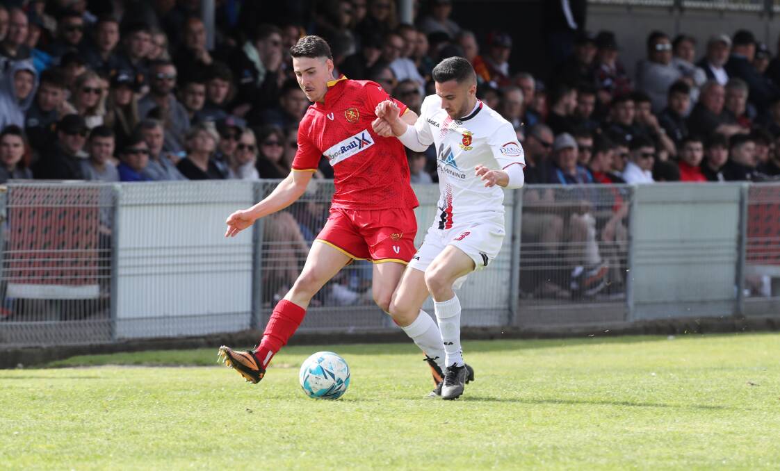 Wollongong United midfielder Josh Correia (left) competes with Cringila opponent Andre Dias for possession during this year's Illawarra Premier League preliminary final at Macedonia Park. Picture by Robert Peet