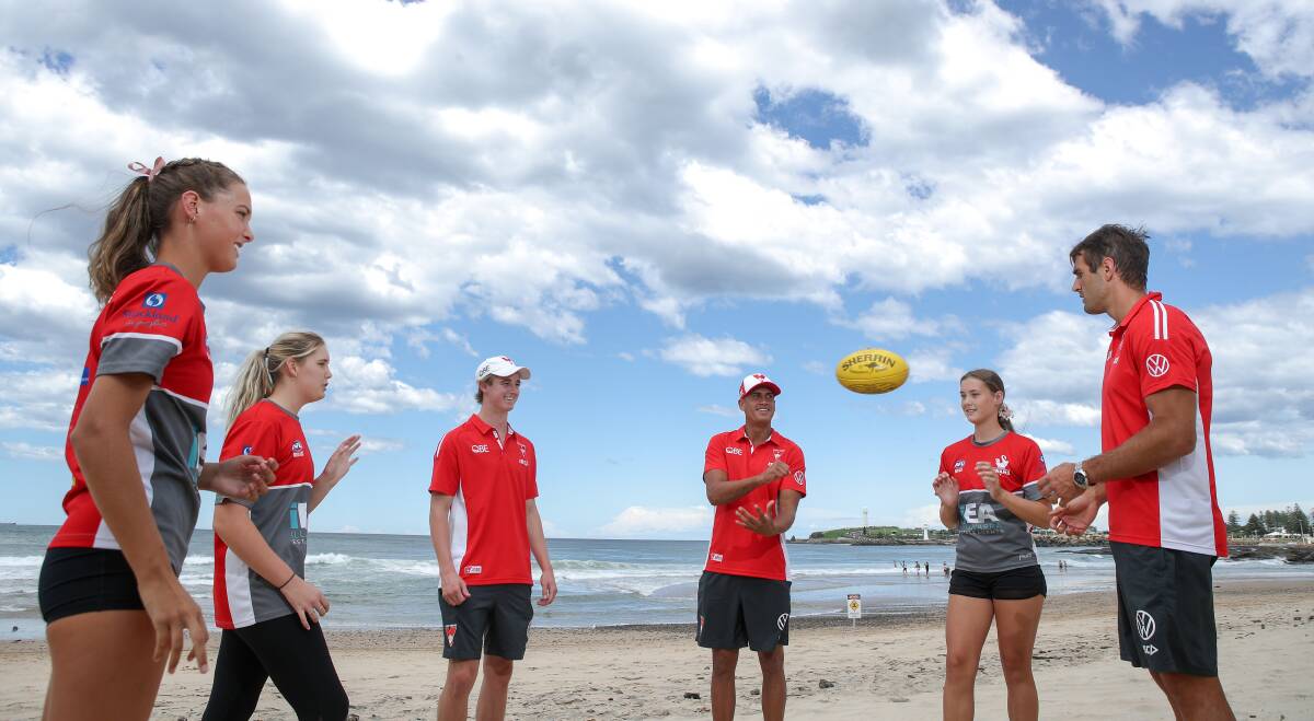 BEACH LIFE: Claire (left), Charlotte and Georgia Ridding meet Sydney Swans Harry Reynolds, James Bell and Josh Kennedy. Picture: Adam McLean