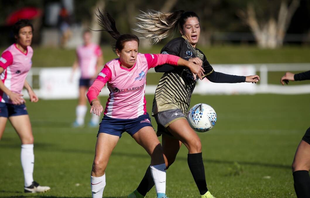 FOCUSED: Stingrays veteran Michelle Carney pushes in front of her opponent during a NSW NPL game last year. Pictures: Anna Warr