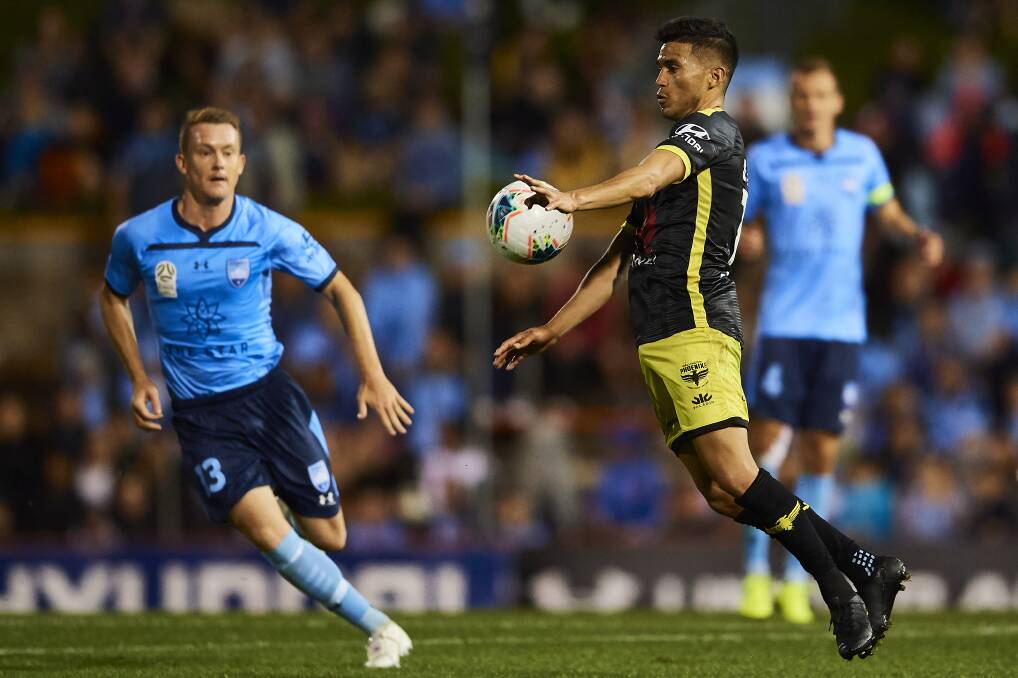 FOCUSED: Ulises Davila (right) looks to control possession against Sydney FC in 2019. Picture: Brett Hemmings/Getty Images