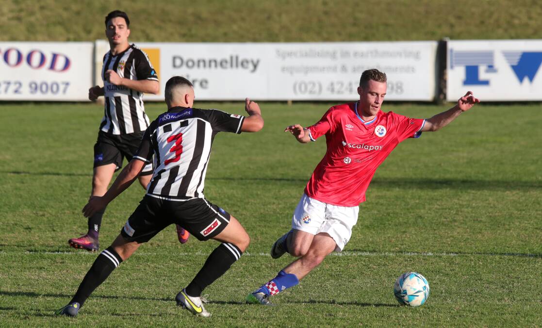 MOVING FORWARD: South Coast United's James Brodnik (right) leads the chase to the ball during a recent IPL game against Port Kembla. Picture: Sylvia Liber