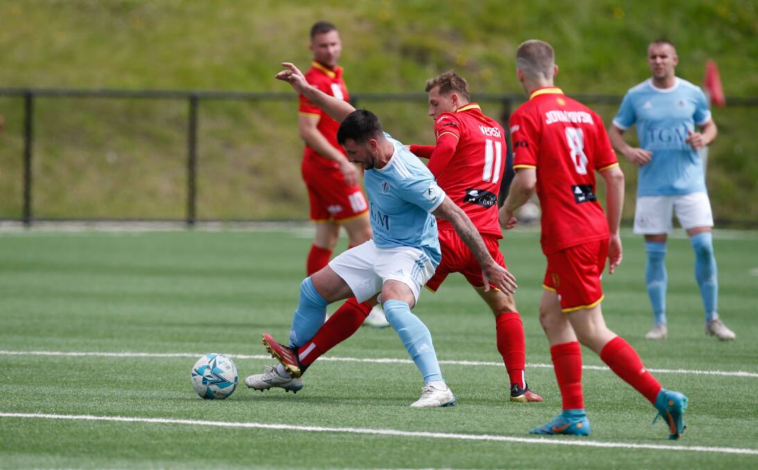 Wollongong Olympic's James O'Rourke (left) and United opponent Mason Versi compete for possession during the recent Illawarra Premier League's major semi-final at Ian McLennan Park. Picture by Anna Warr