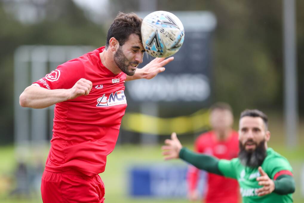 MOVING FORWARD: Wollongong Wolves player Ethan Kambisios heads the ball during last Sunday's game against Marconi. Picture: Adam McLean