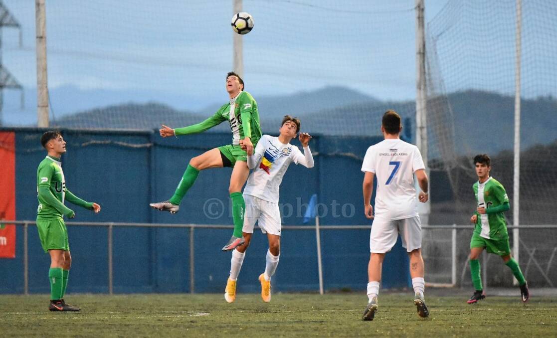 FLYING HIGH: Illawarra teenager Thymos Caroutas jumps and looks to control possession during a recent game for Spanish club, UE Cornella. Picture: Supplied by Meni Caroutas