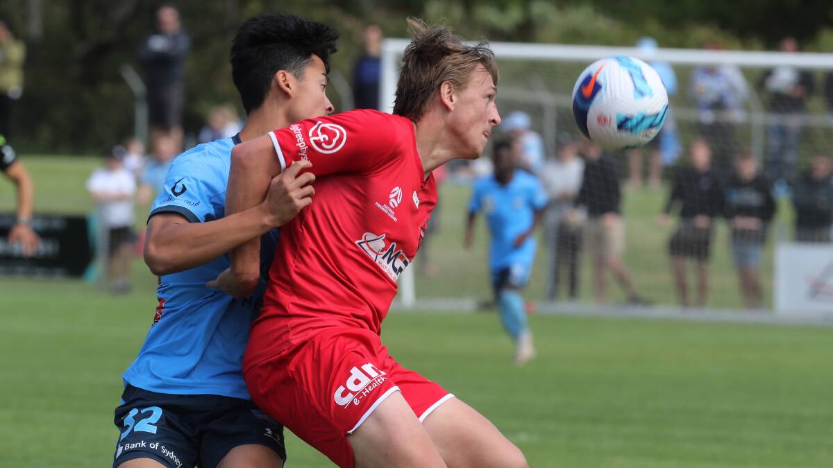 IN FOCUS: Wollongong Wolves striker Lachlan Scott keeps a close eye on the ball ahead of Sydney FC opponent Cameron Fong on Saturday. Picture: Robert Peet