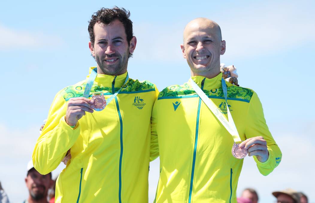 DELIGHT: Wollongong-based athlete Jonathan Goerlach (right) - pictured with his guide David Mainwaring - celebrate after claiming bronze in the Men's PTVI triathlon event at the 2022 Commonwealth Games over the weekend. Picture: Al Bello/Getty Images