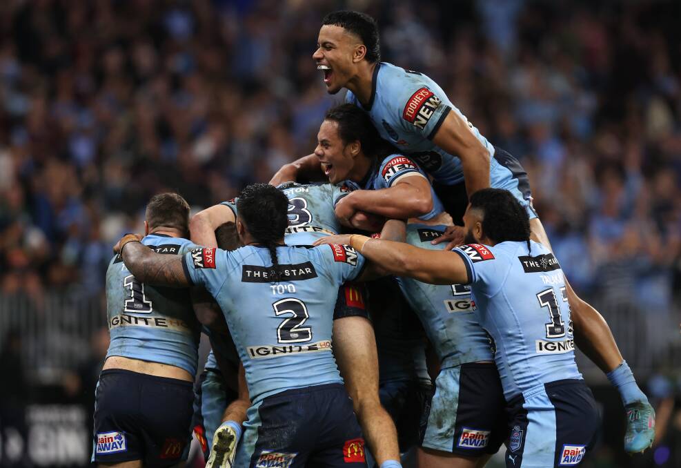 HAPPY DAYS: Stephen Crichton (top) and his Blues teammates celebrate after Nathan Cleary scored a try on Sunday night. Picture: Paul Kane/Getty Images
