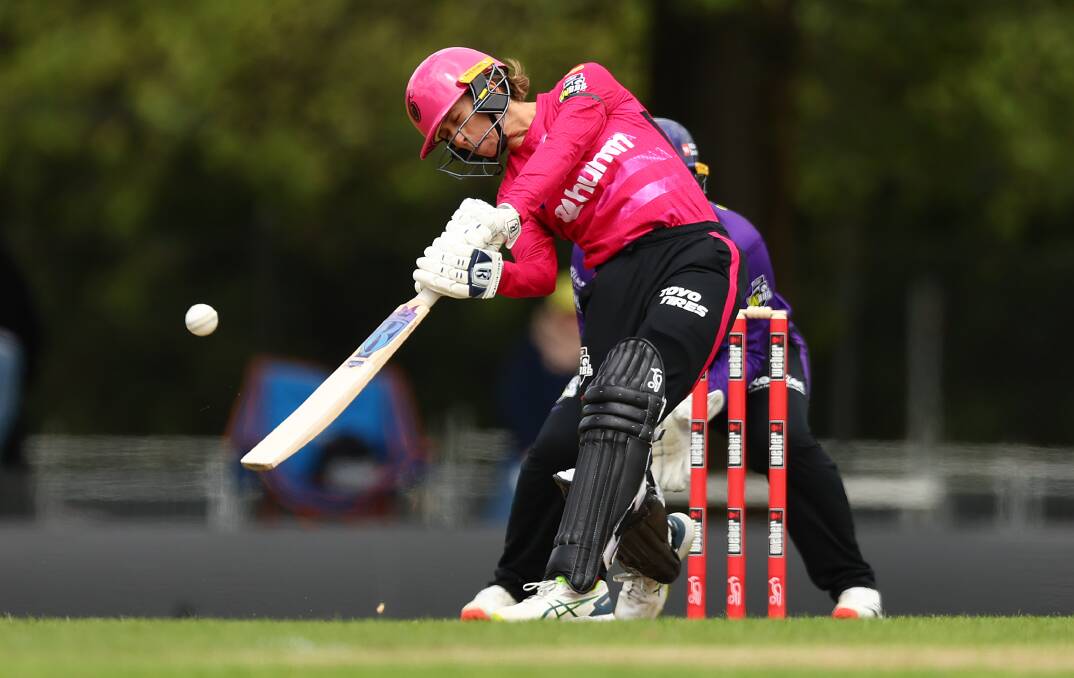 Sydney Sixers all-rounder Erin Burns smashes a boundary against the Hurricanes at Eastern Oval earlier this season. Picture by Graham Denholm/Getty Images