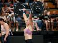 Emily Clements maintains her overhead lifting form during last year's Down Under Championship at the WIN Entertainment Centre. Picture by Anna Warr