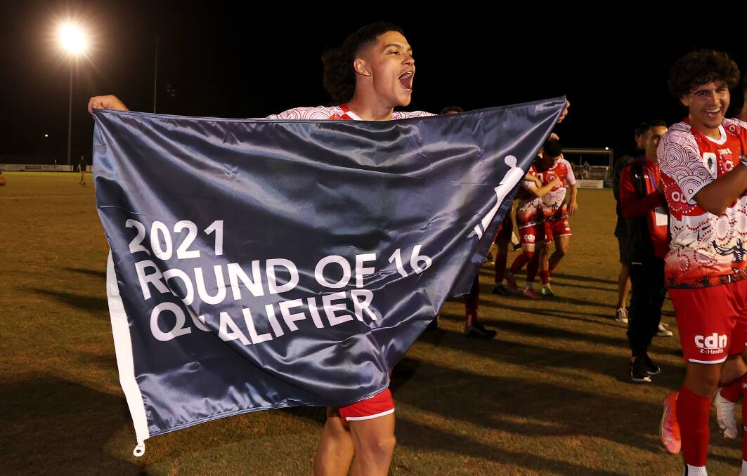LOOKING FORWARD: Wollongong Wolves player Bilal Belkadi celebrates victory with the FFA Cup's round of 16 qualifier flag after beating Mount Druitt earlier this month. Picture: Mark Kolbe/Getty Images