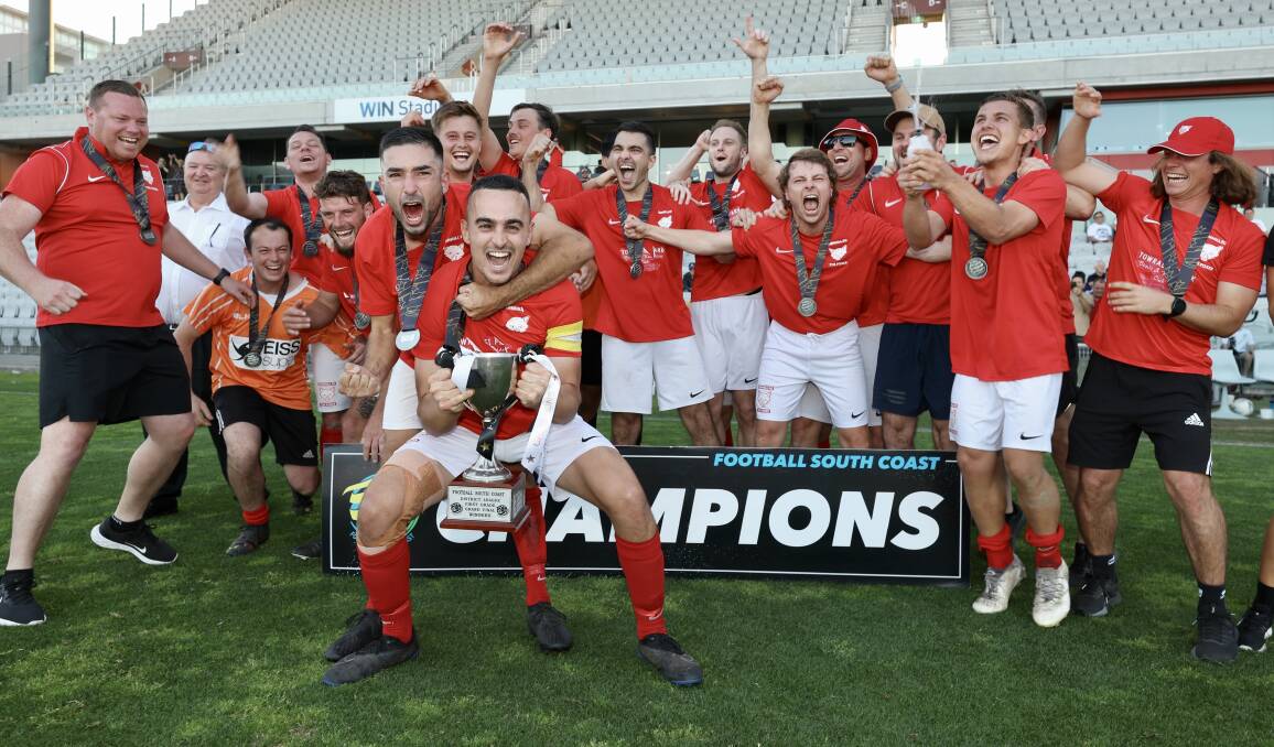 Fernhill captain Jordan Hughes (front) and his teammates celebrate with the spoils after winning Saturday's grand final. Picture by Adam McLean