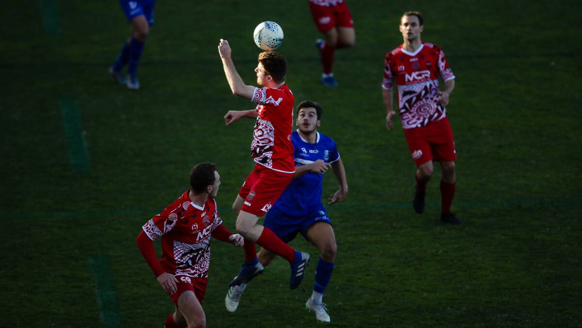Wolves defender Nick Littler heads the ball against Hakoah Sydney City East at WIN Stadium last year. Picture: Adam McLean