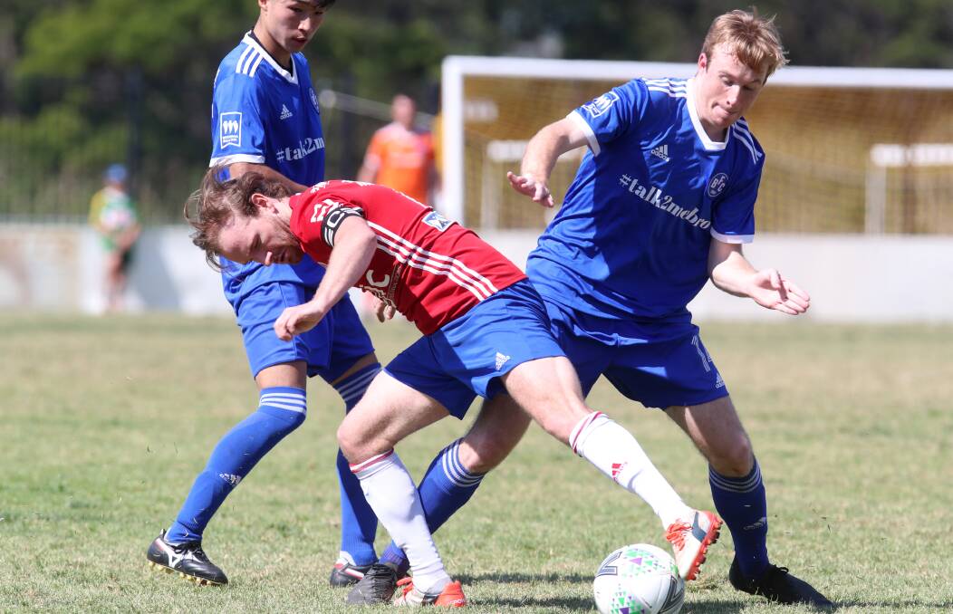 ON THE LINE: Albion Park's Chris Nathaniel (left) and Bulli opponent Dylan Lewis battle for possession recently. Picture: Sylvia Liber