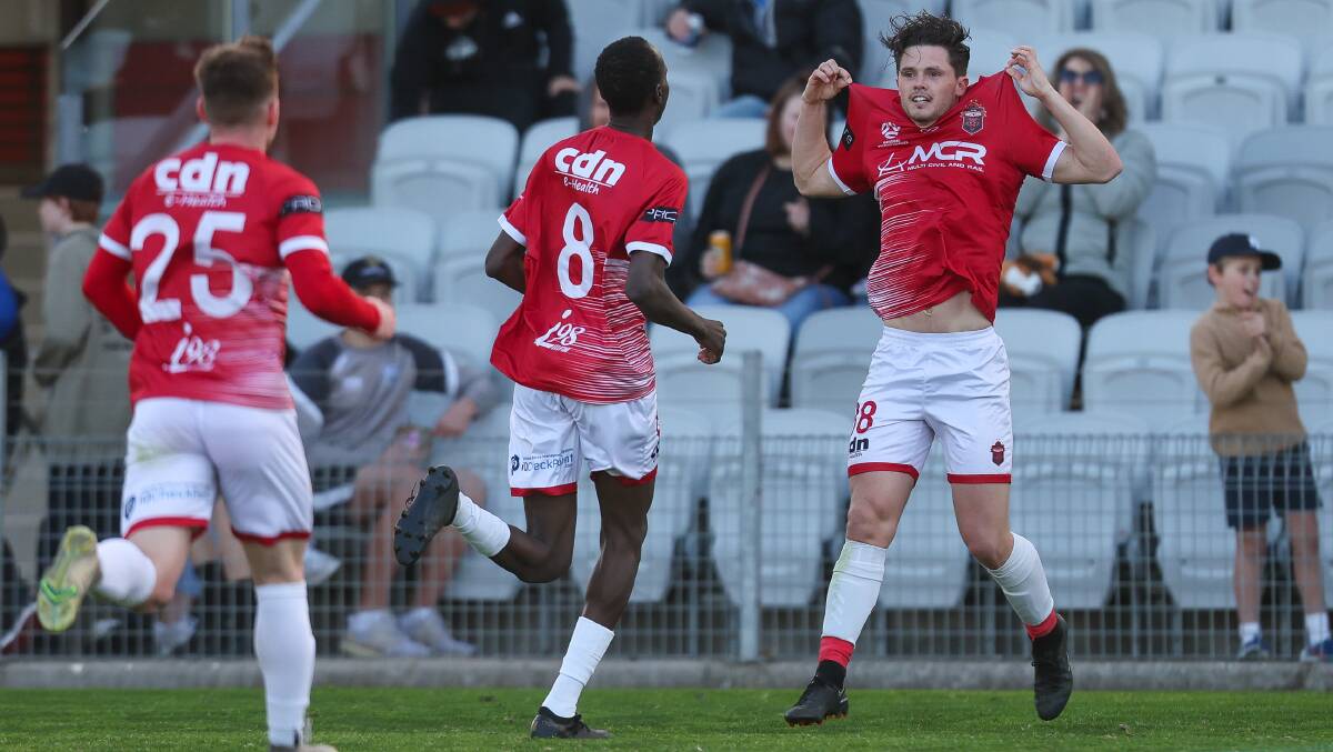 Wollongong Wolves player Chris McStay (right) celebrates with his teammates after scoring a goal at WIN Stadium earlier this year. Picture by Adam McLean 