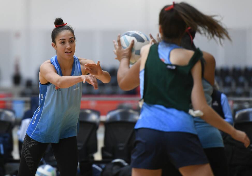 PROUD: Figtree's Mia Evans passes the ball at a recent NSW training session. Picture: Nigel Owen/Netball NSW