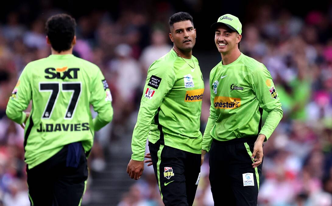 Blake Nikitaras (right) celebrates a wicket with Thunder teammate Gurinder Sandhu on Saturday night. Picture by Brendon Thorne/Getty Images