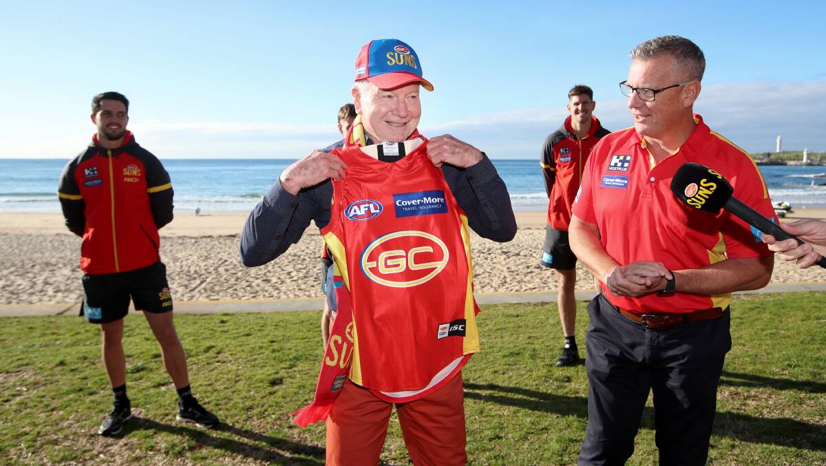ON BOARD: Wollongong Lord Mayor Gordon Bradbery receives a Suns jersey from Gold Coast CEO Mark Evans. Picture: Sylvia Liber