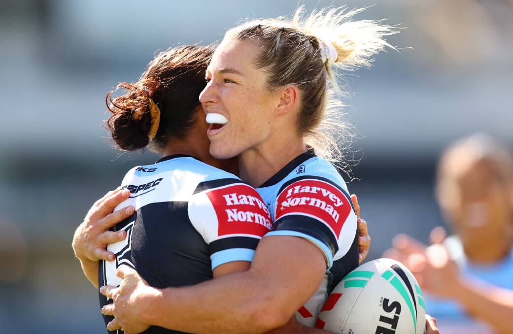 Illawarra star Emma Tonegato celebrates with a Sharks teammate after scoring a try last year. Picture by Mark Nolan/Getty Images