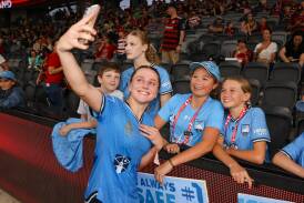 Horsley's Caley Tallon-Henniker poses for a photo with young Sydney FC fans at CommBank Stadium on Saturday night. Picture - Sydney FC