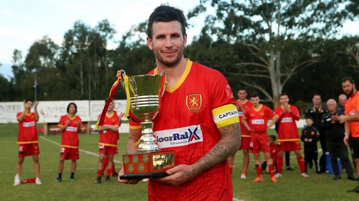 Wollongong United captain James O'Rourke holds up the Frat Cup trophy at Memorial Park on July 20. Picture: Sylvia Liber