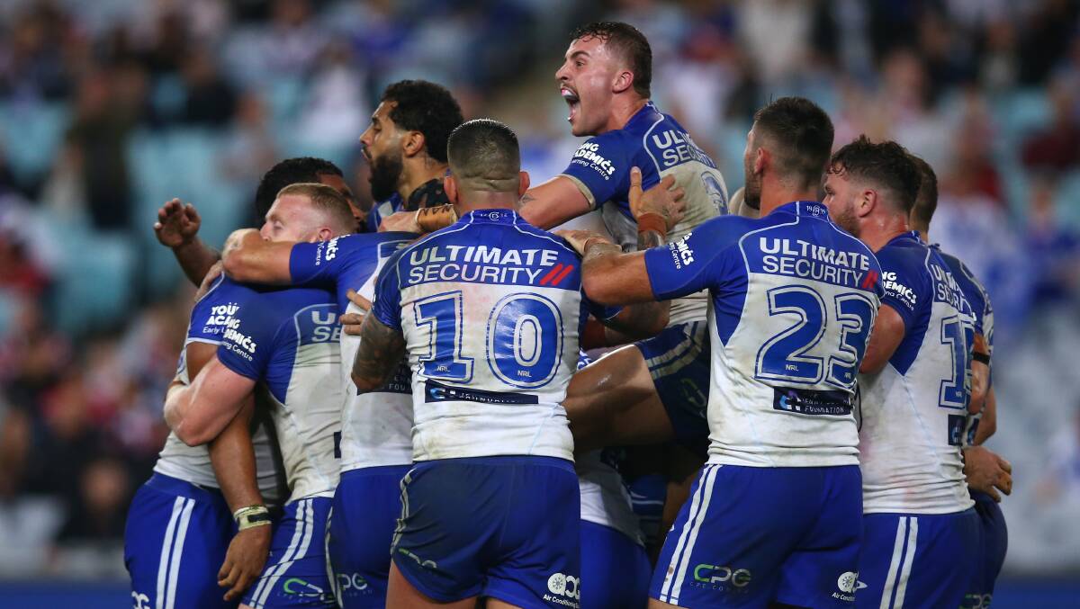 HAPPY DAYS: Aaron Schoupp (centre) celebrates with his Bulldogs teammates after they defeated the Roosters. Picture: Jason McCawley/Getty Images