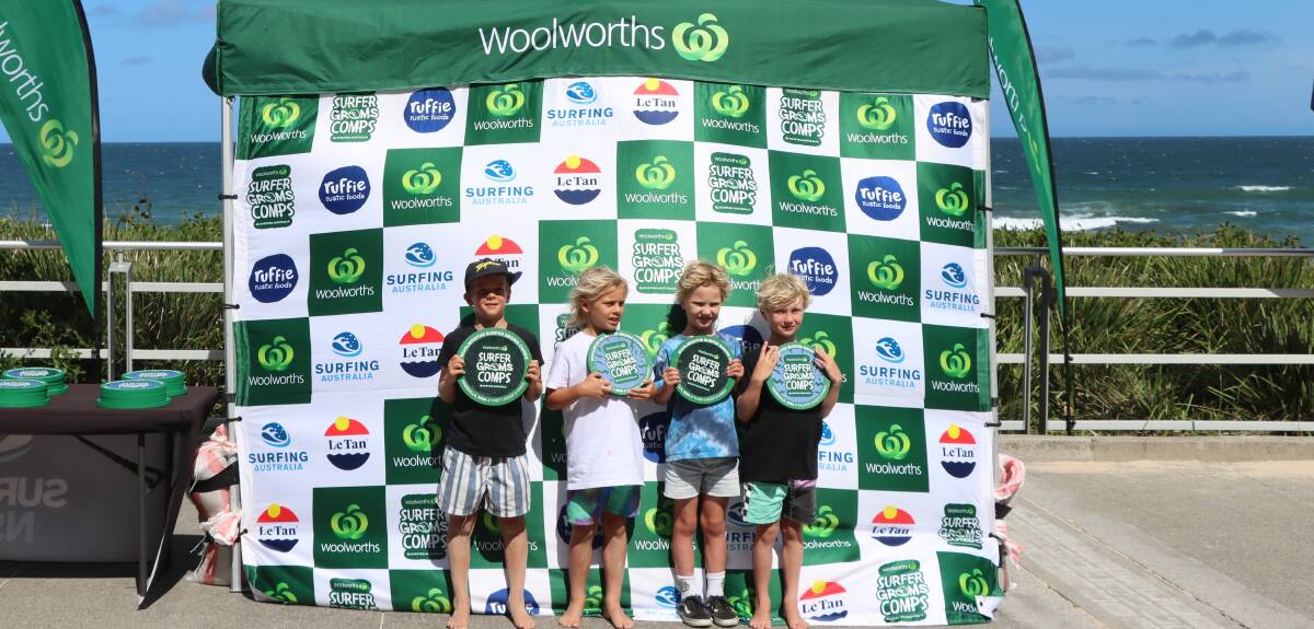 The under-eights mixed winners smile after receiving their awards on Sunday at North Cronulla Beach. Picture - Surfing NSW