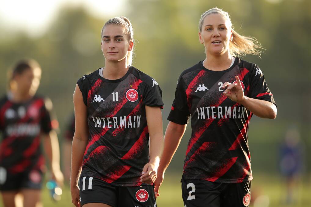 TICKLED PINK: Wanderers duo Danika Matos and Caitlin Cooper warm up together ahead of a game. Picture: Matt King/Getty Images