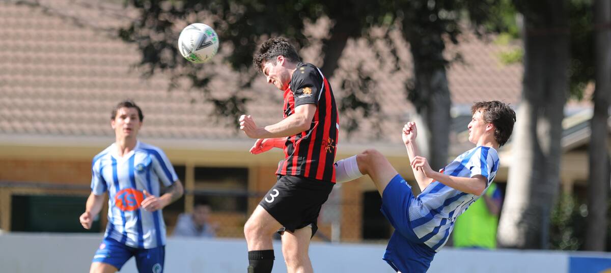FOCUSED: Cringila's Jake Bailey heads the ball during a game against the Blueys last season. Picture: Robert Peet