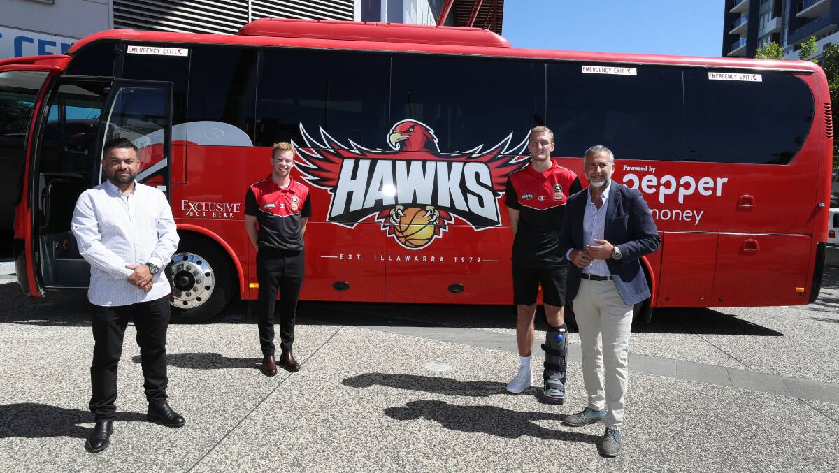 ON A ROLL: Ariel Vargas from Exclusive Bus Hire, Hawks players Lachlan Dent and Daniel Grida, and Hawks co-owner and president Dorry Kordahi with the Hawks Bus. Picture: Robert Peet