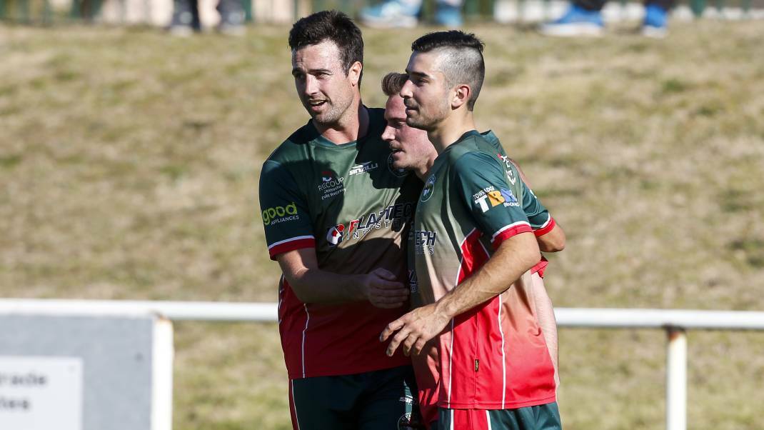 Brad Watts (centre) celebrates with his Bellambi teammates after scoring a goal. Picture: Anna Warr