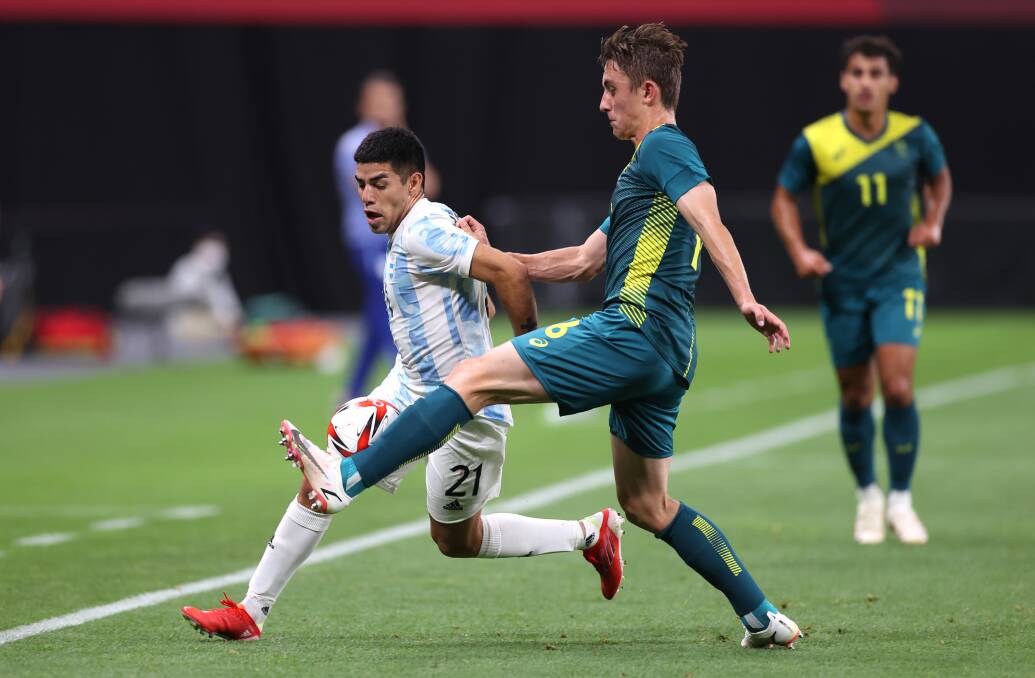 WORKING HARD: Olyroos defender Joel King competes with an Argentina opponent for possession in Sapporo. Picture: Masashi Hara/Getty Images