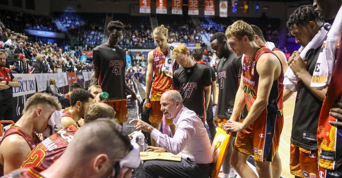 Alkodah Gak (back, left) and Hawks teammates listen to instructions from coach Brian Goorjian during Sunday's game against the 36ers. Picture: Adam McLean