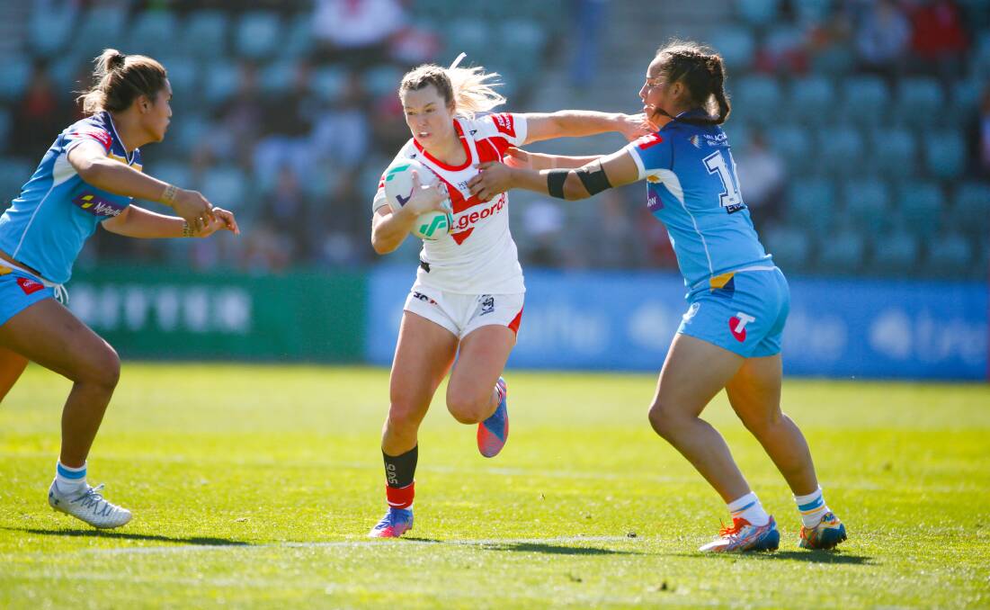 Dragons fullback Emma Tonegato looks to burst her way past two Titans defenders during a NRLW game at WIN Stadium this year. Picture by Anna Warr