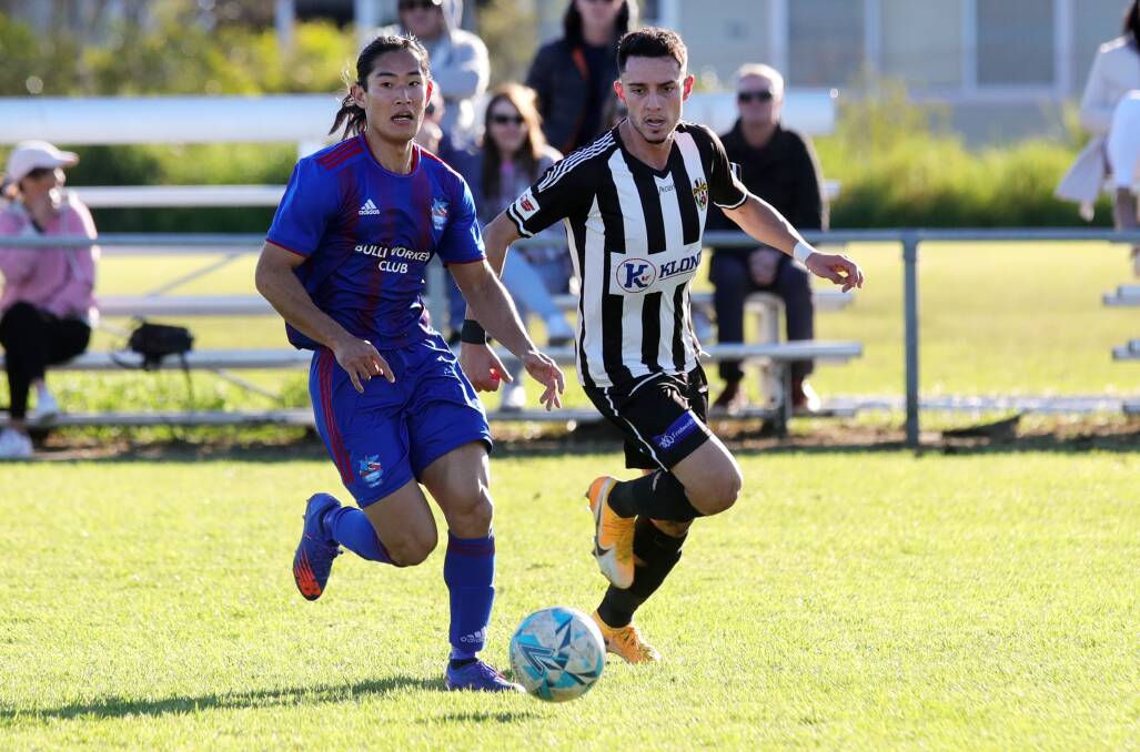 FOCUSED: Woonona's Shin Takahashi (left) and his Port Kembla opponent keep their eyes on the ball at Ocean Park. Picture: Sylvia Liber