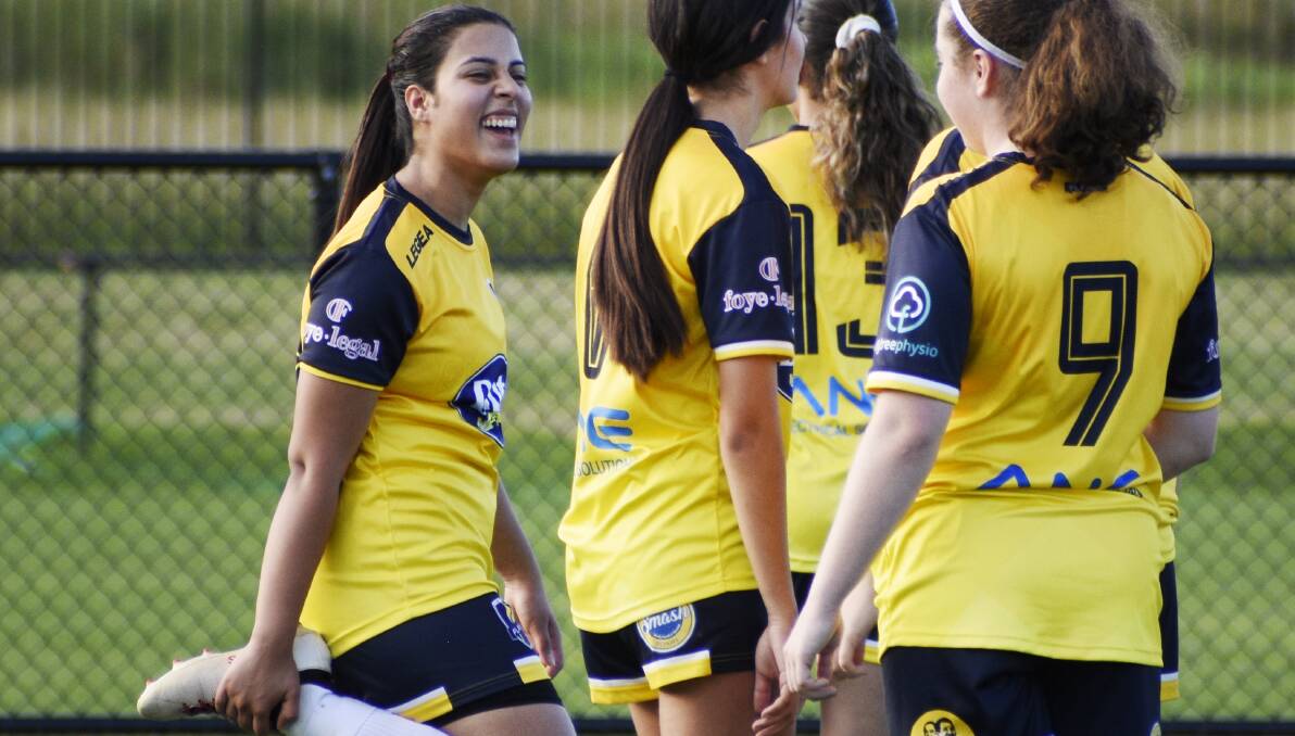 HAPPY: Zinah Hasan shares a joke with a South Coast Flame teammate. Picture: Multicultural Communities Council of Illawarra 