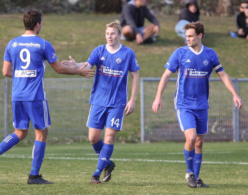 BACK IN ACTION: Dylan Lewis high fives a Bulli FC team mate after scoring a goal. Picture: Georgia Matts
