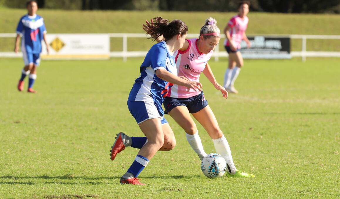 HAPPY IN PINK: Erica Halloway looks to pass the ball to an Illawarra Stingrays teammate during a game against Sydney Olympic last year. Picture: Sylvia Liber