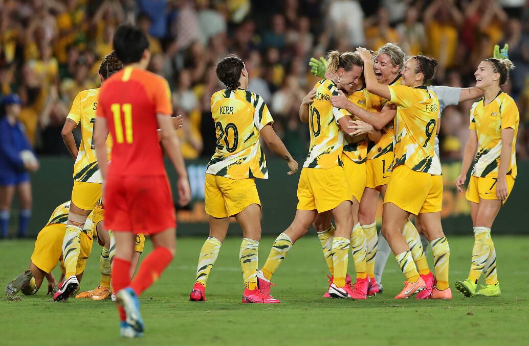 JUBILANT: Caitlin Foord (second from right) and her Matildas teammates embrace after Emily van Egmond drills home a goal to draw level at 1-all against China on Thursday night. Picture: Mark Metcalfe/Getty Images