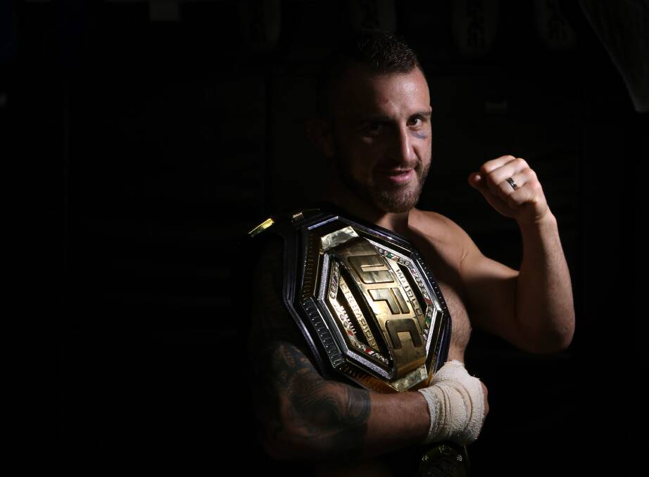 REWARDED: Alex Volkanovski proudly holds up the UFC world featherweight title belt. Picture: Sylvia Liber