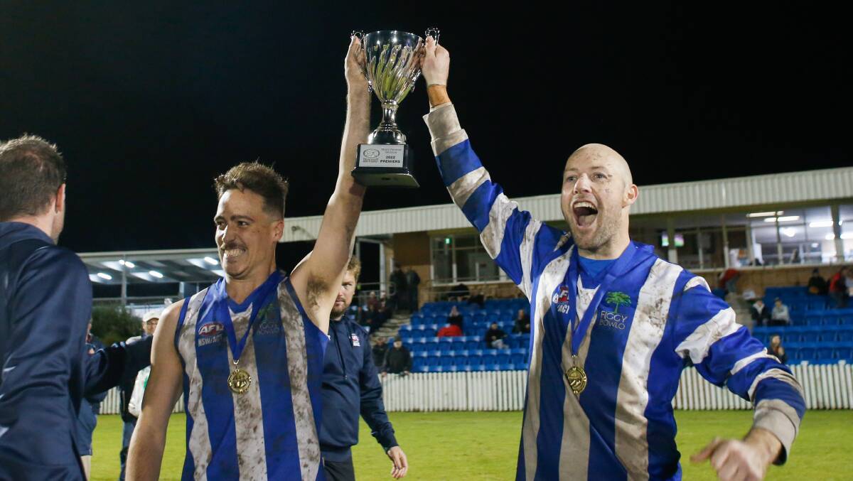 Figtree captain Jacob Hennessy and head coach Michael Coleman hold up the spoils after this year's grand final at North Dalton Park. Picture by Anna Warr