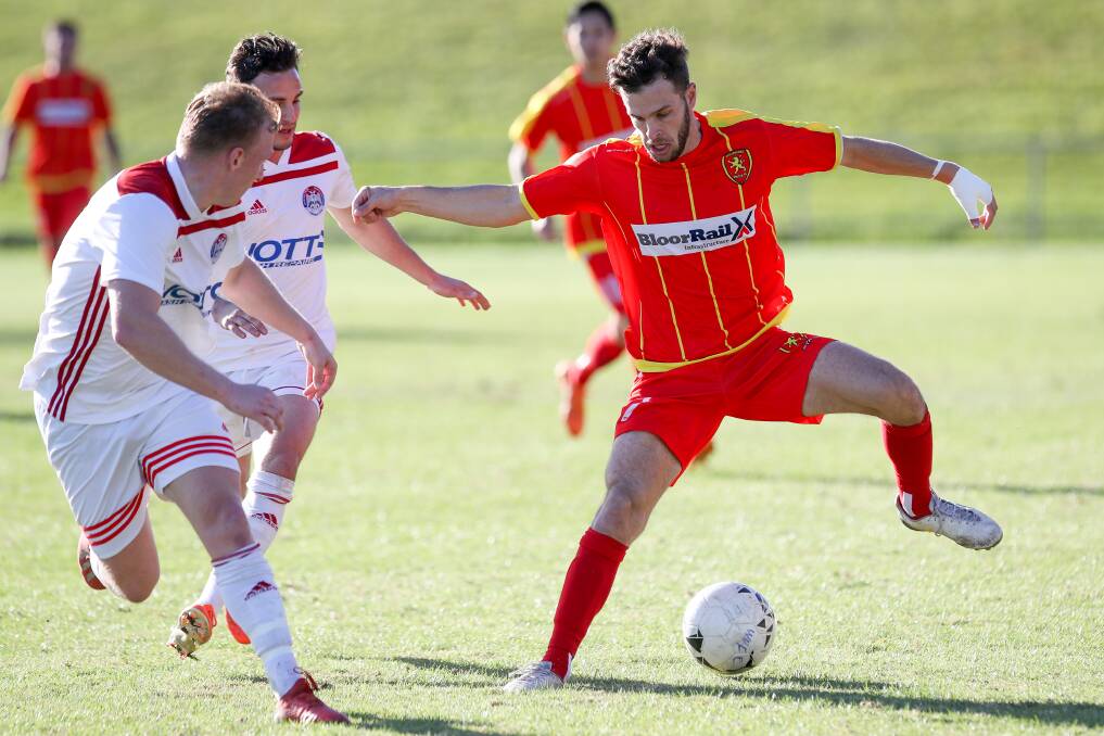 IN CONTROL: Wollongong United's Kane Wright looks to get the ball around an Albion Park opponent. Picture: Adam McLean