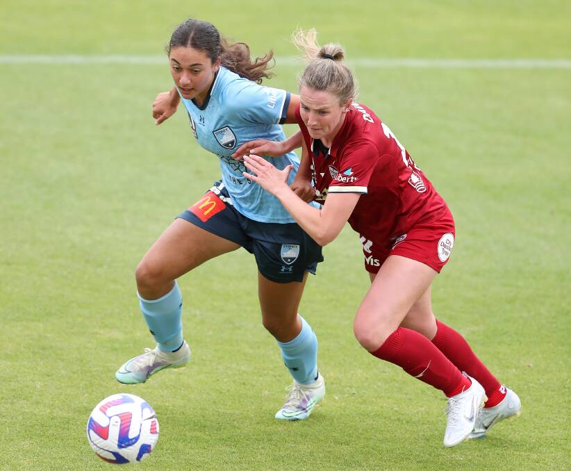Sydney FC's Jynaya Dos Santos (left) battles with Adelaide United opponent Chelsea Dawber at ServiceFM Stadium on Sunday. Picture by Sarah Reed/Getty Images