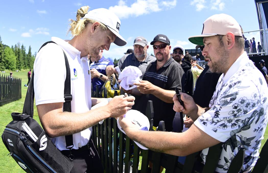 HAPPY DAYS: Travis Smyth signs his autograph for a fan during the LIV Golf Invitational in Portland. Picture: Charles Laberge/LIV Golf via Getty Images