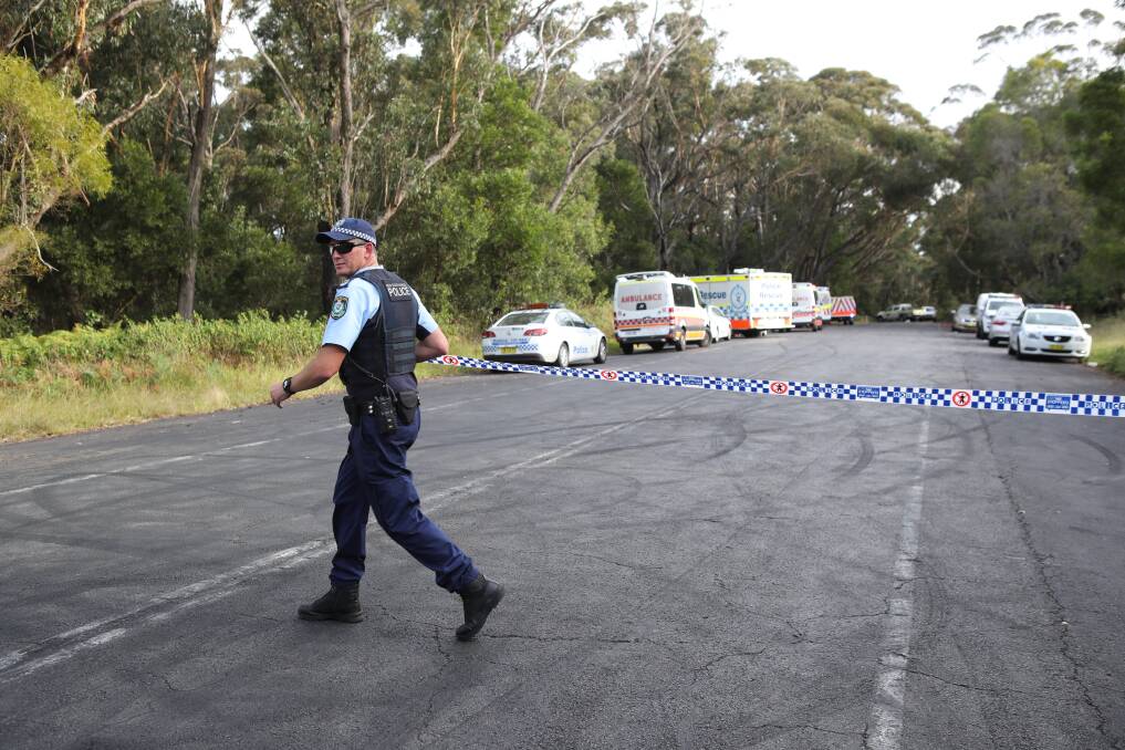 Crime scene: Police block the road to investigate the shock death of a woman and child on Tuesday. Pictures: Adam McLean