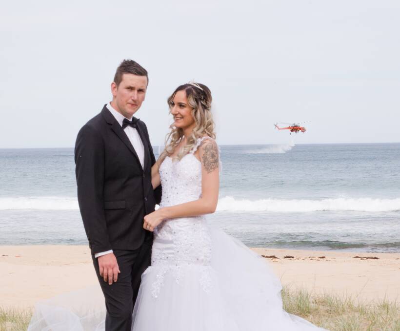 Photobombed: Newlyweds Brodie-Lea and Adam Scott won't forget in a hurry they tied the knot the day the northern suburbs were given a taste of the bushfire season. Picture: Matt Estherby