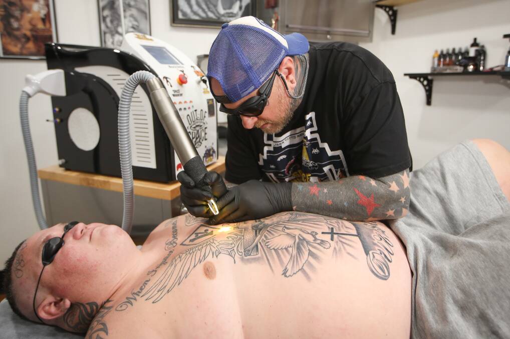 Laser: Lance Daly removing the "one per cent" tattoo that weighs heavy on the chest of Luke Hainsworth.