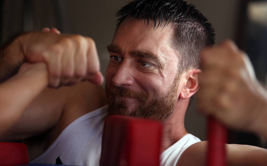 Muscle up: Shannon Michels training for the arm wresting national titles in Melbourne. He's one of a handful of serious Illawarra competitors. Picture: Robert Peet