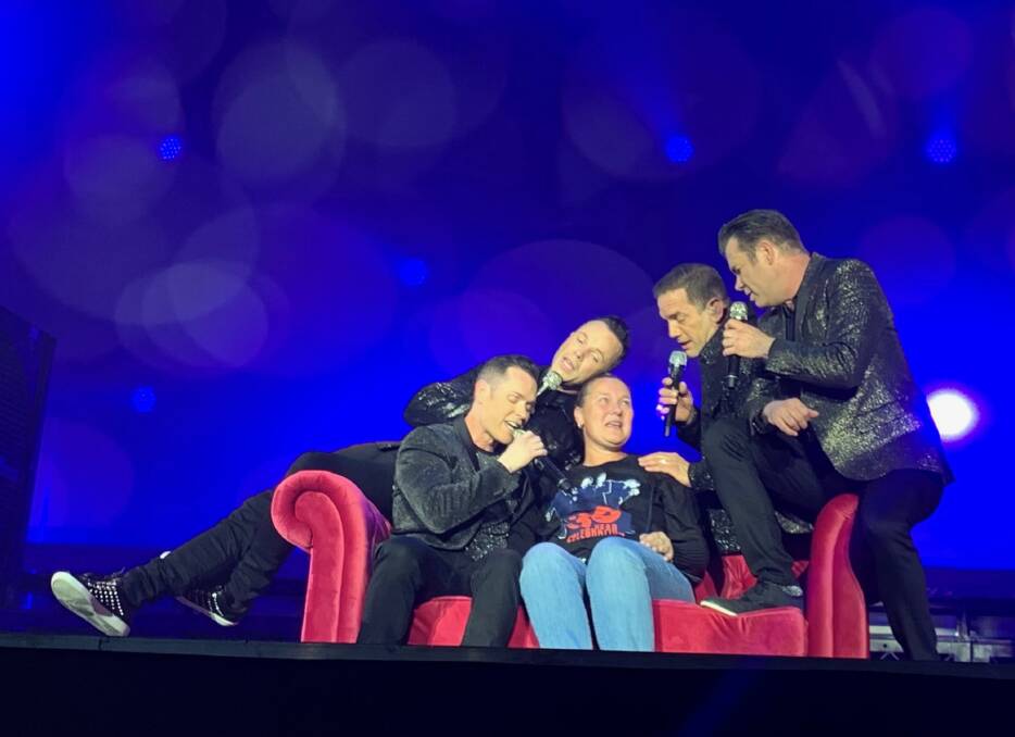 Feeling the love: Berekeley mum Amanda-Renee Shepherd up close and personal with her favourite band of all time. Photo: Kerrie Lawrence 