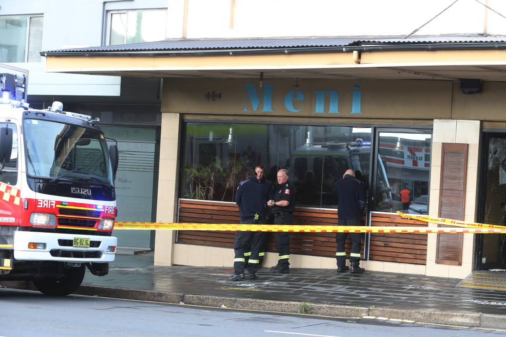 Firefighters examined the scene, determining the fire started in several domestic waste bins close to the external wall of the cafe. Picture: Robert Peet